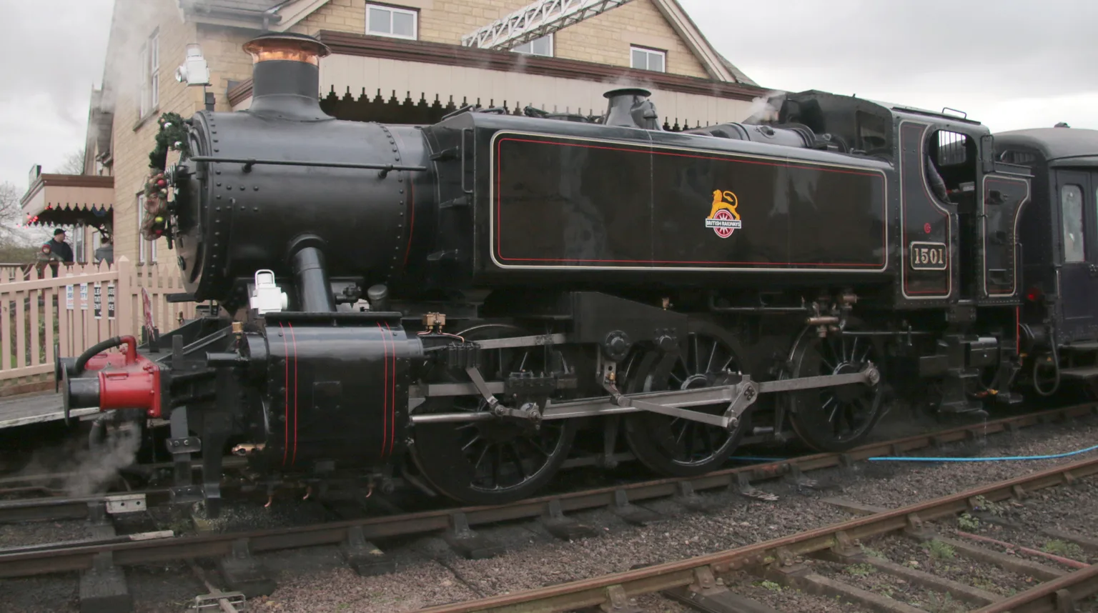 A black pannier tank engine numbered 1501 standing at Wansford station under a grey winter sky