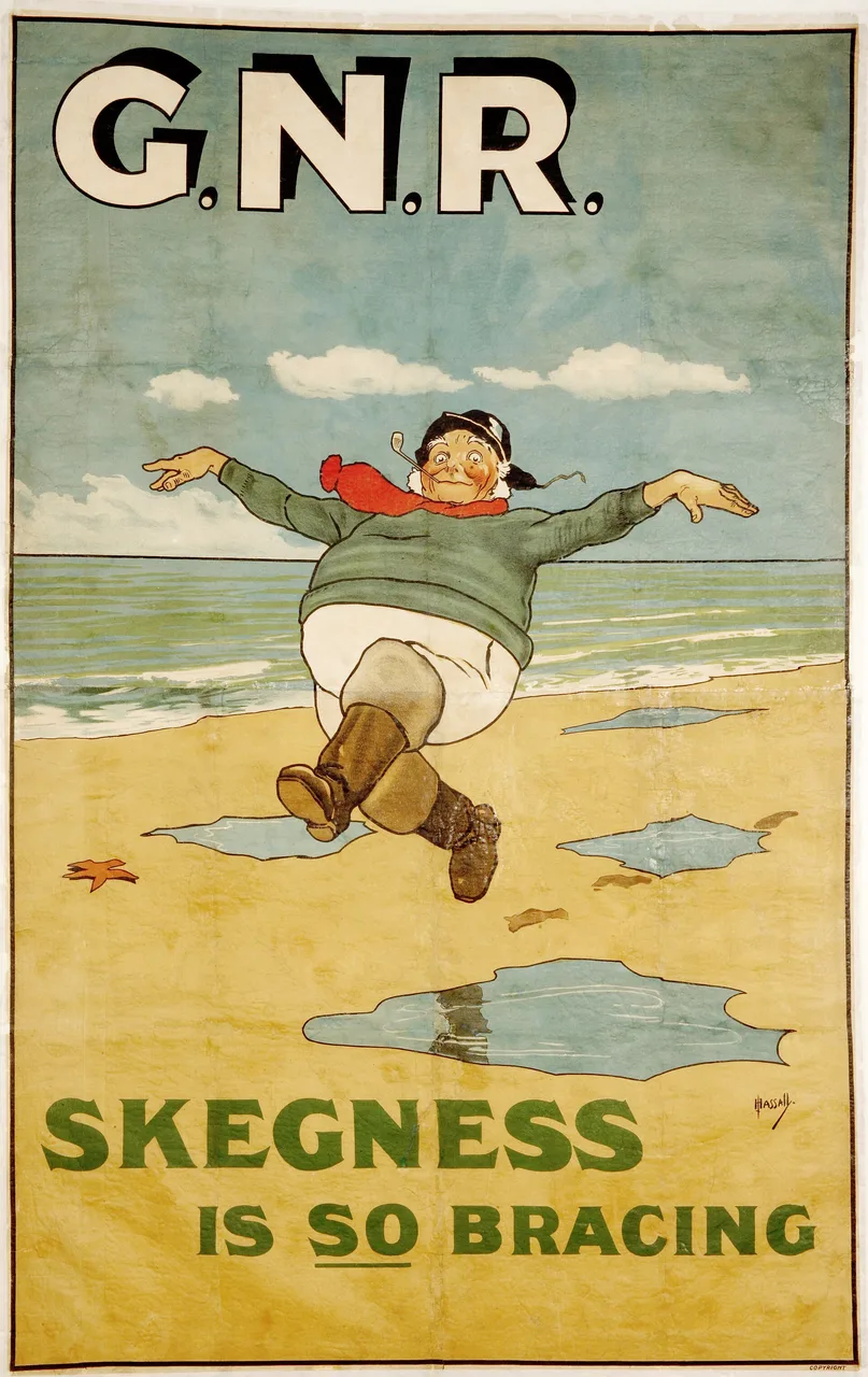 John Hassall’s 1908 Great Northern Railway poster Skegness is So Bracing: the Jolly Fisherman skipping along a wet beach, scarf flying, with G.N.R. in big letters at the top.